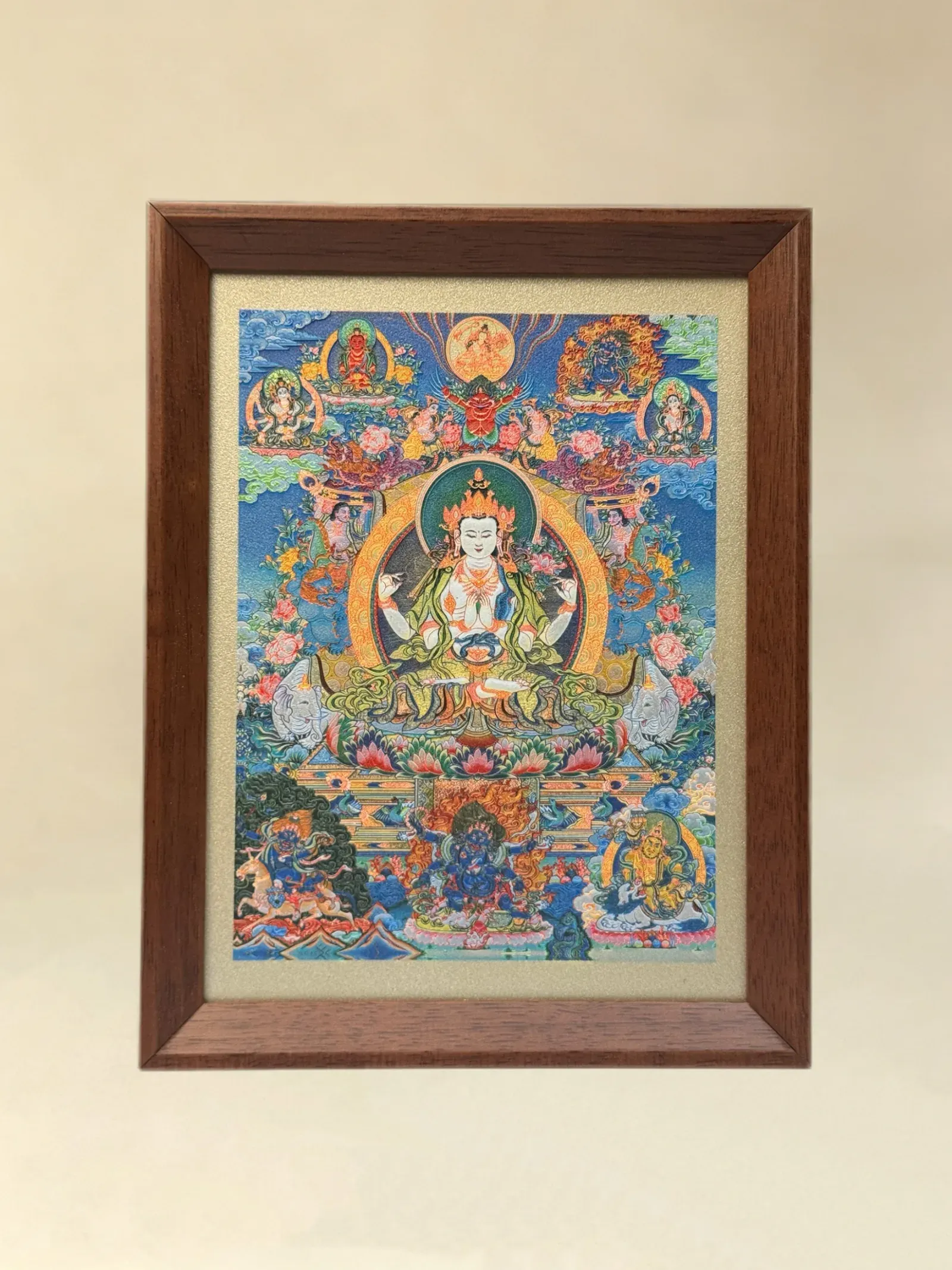 A relief artwork of Four-Armed Avalokiteshvara, with surrounding figures, as a desktop frame, photographed front on.