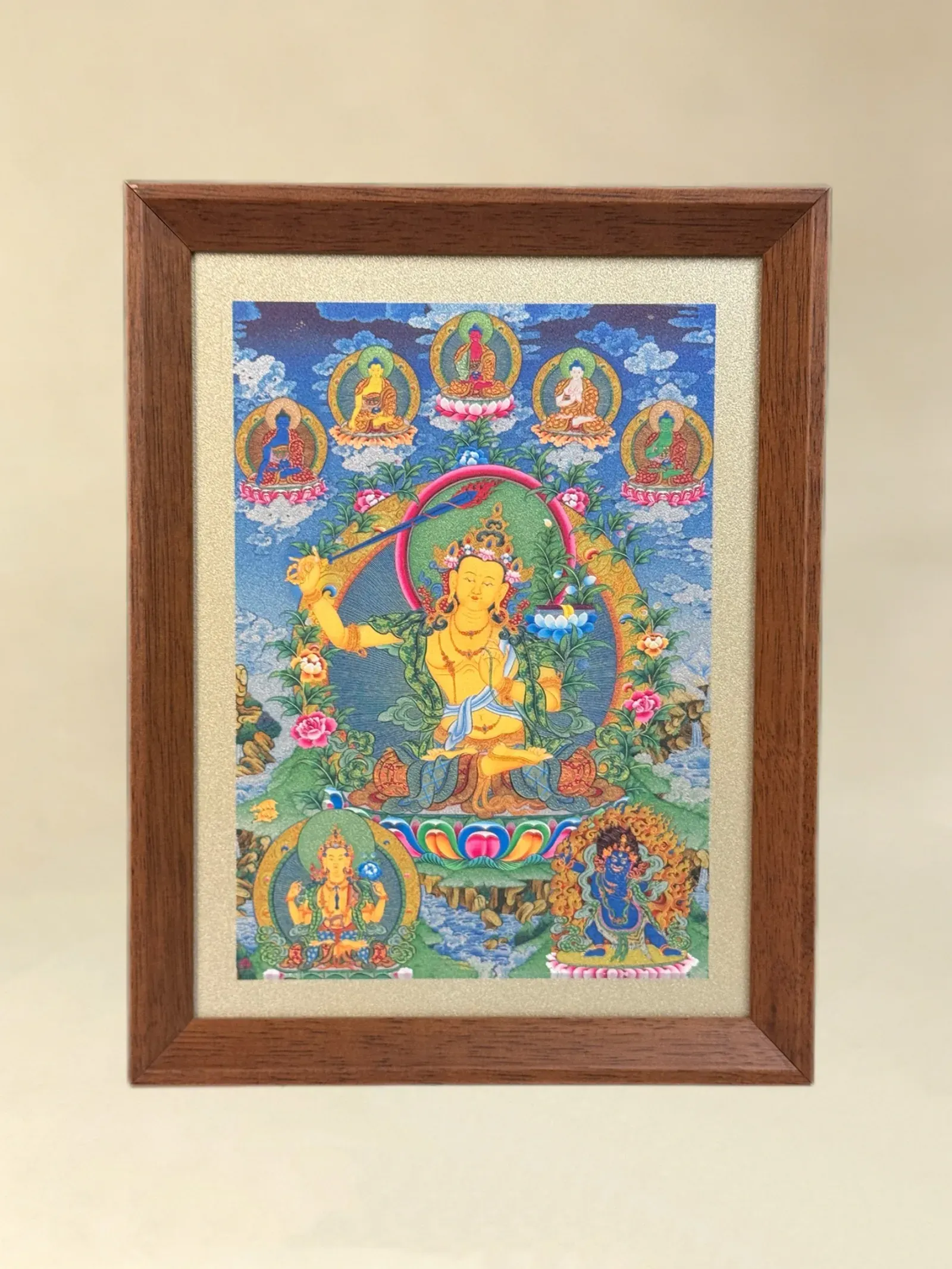 A relief artwork of Manjushri, as a desktop frame, photographed front on.