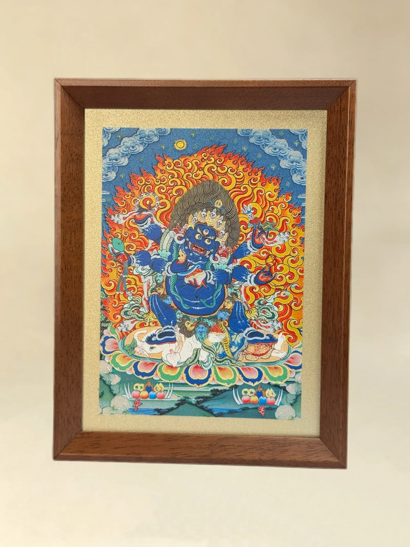 A relief artwork of Six-Armed Mahakala, as a desktop frame, photographed front on.