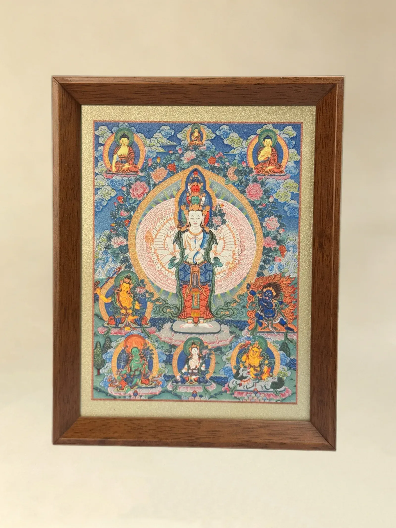 A relief artwork of Eleven-Headed Thousand-Armed Avalokiteshvara, as a desktop frame, photographed front on.